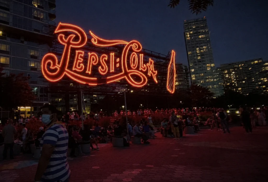 Glowing neon sign on restaurant shopfront at dusk — neon signs usually require council approval