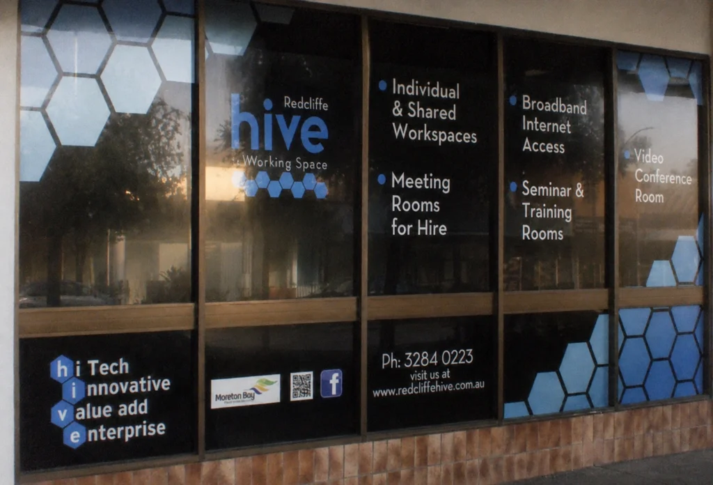 Window vinyl graphics and lettering on retail shopfront — window signage example