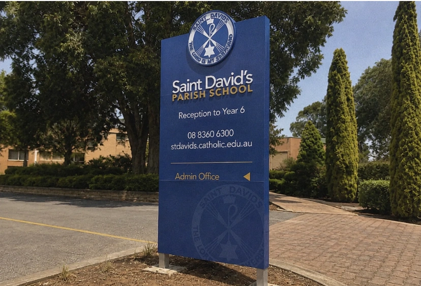 Tall pylon pole sign in commercial car park — large freestanding signage structure